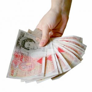 A hand offering money. Donations needed.